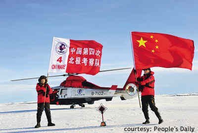 Two people with flags on the North Pole, helicopter in the back