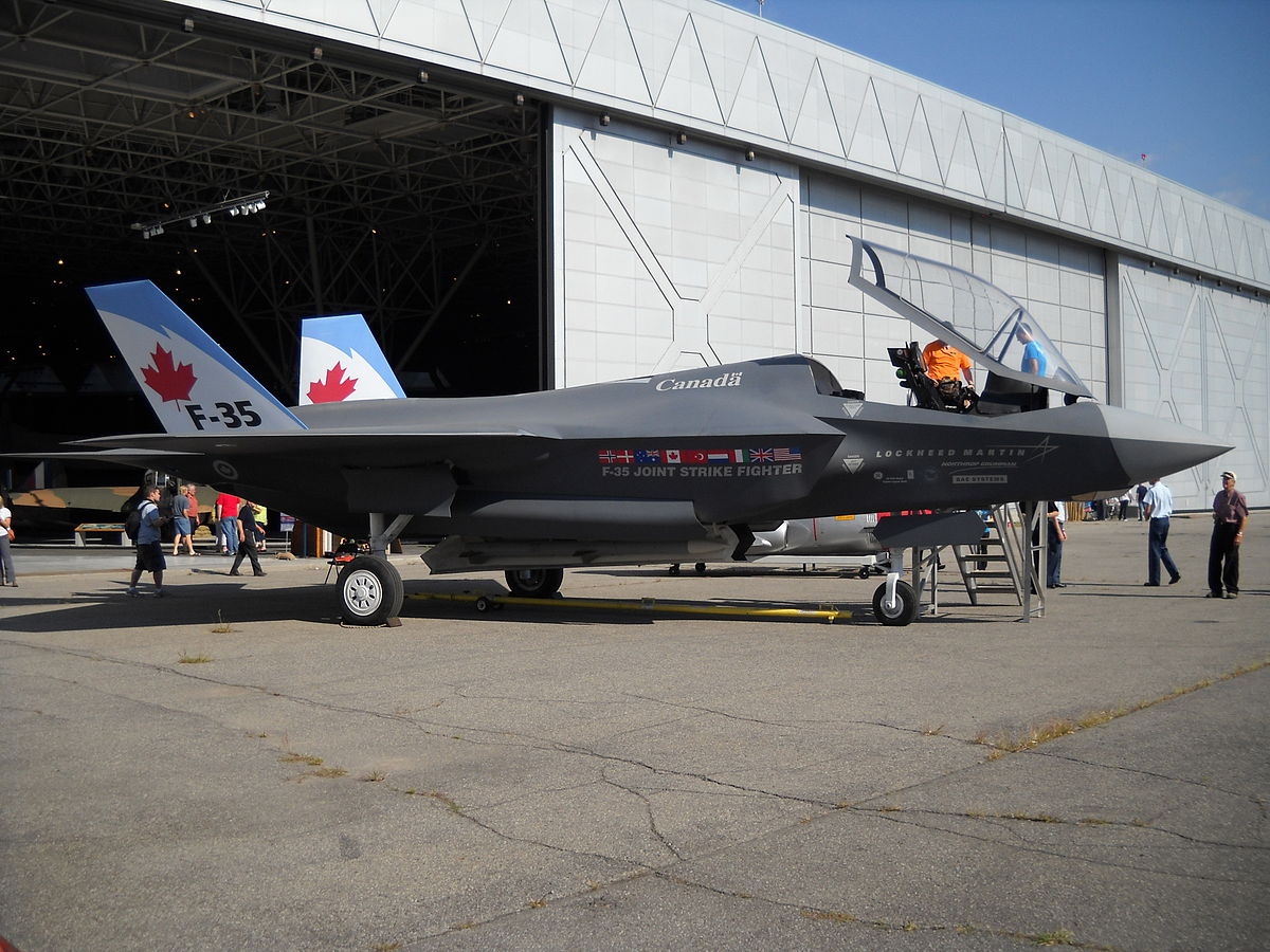 Fighter jet in front of hangar