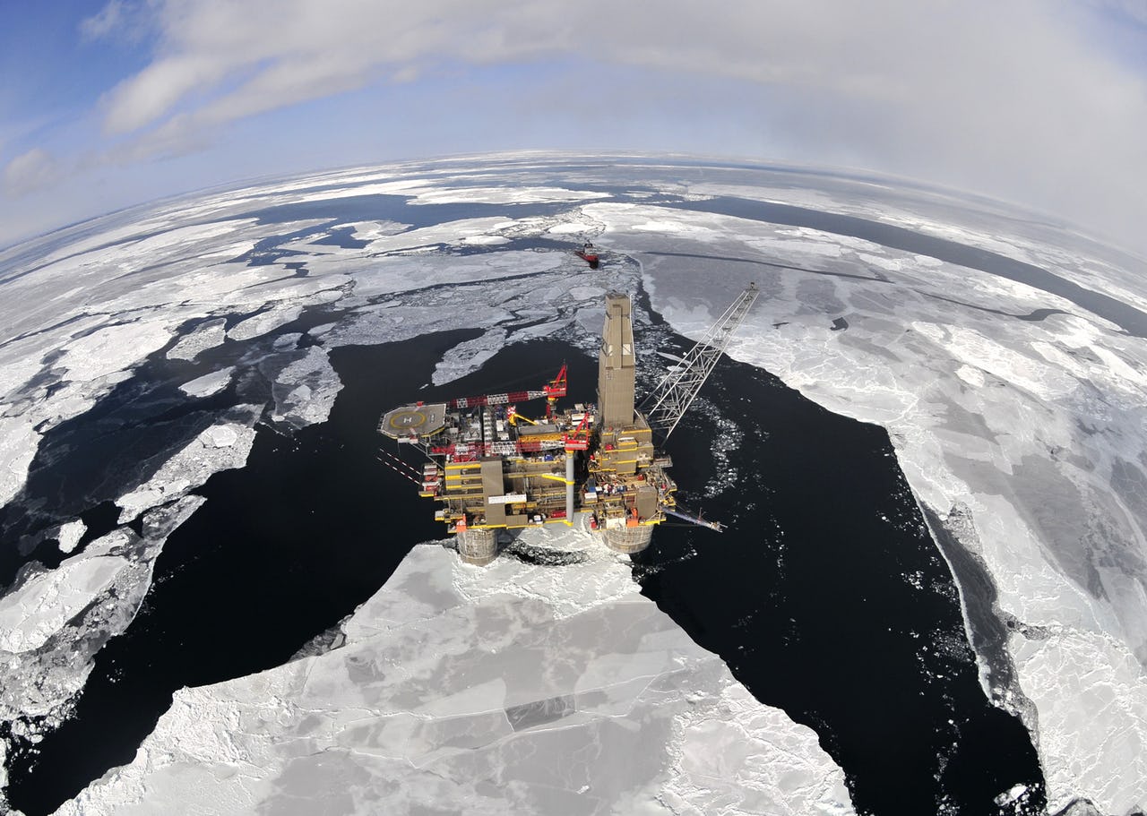 Arial shot of oil and gas platform surrounded by ice floes