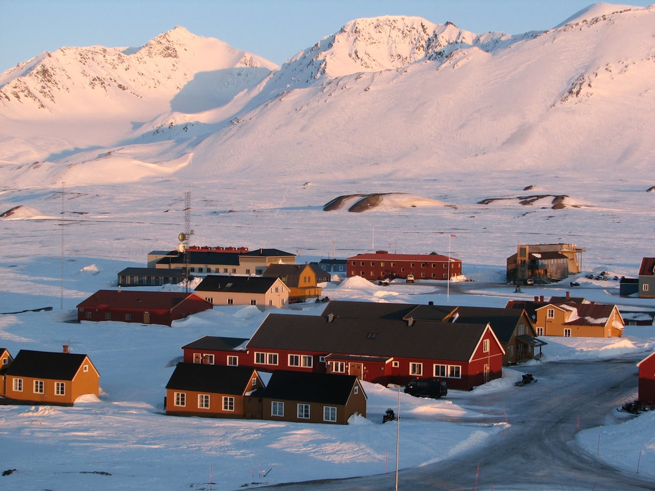 Houses surrounded by snowy mountains