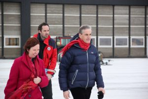 Three people walking and smiling