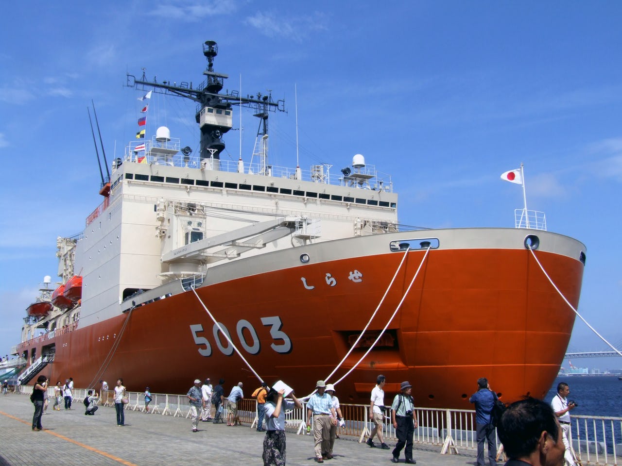 Icebreaker in harbour with people taking pictures of it