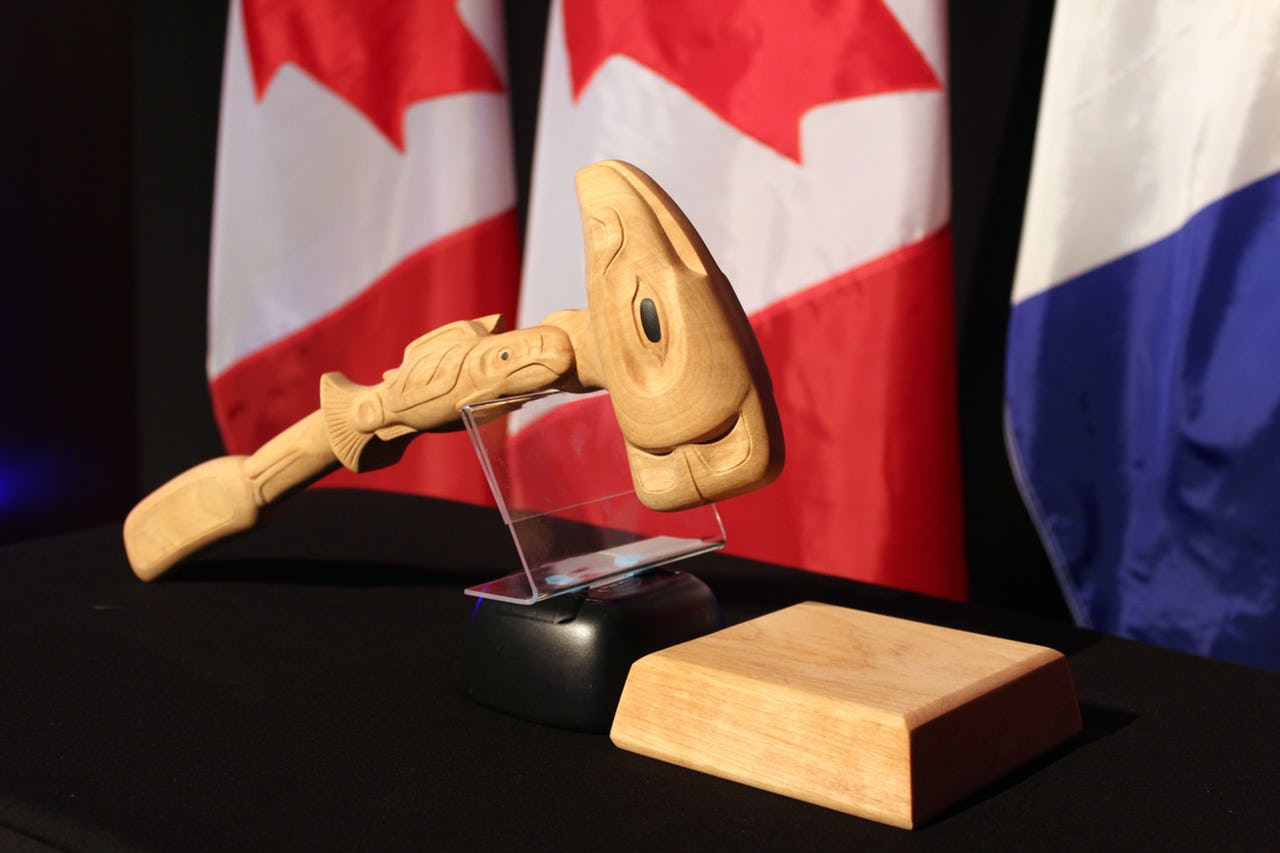 Gavel made of wood on table with flags as background