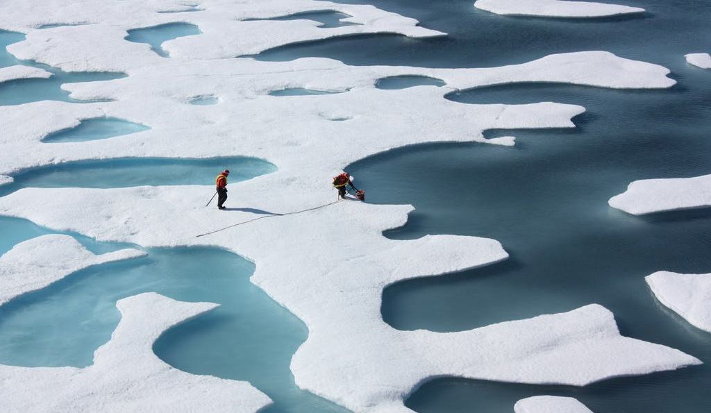 Two NASA Arctic scientist researchers study melt ponds, ice, and water to examine chemistry and plankton in the Arctic Ocean as part of the ICESCAPE mission