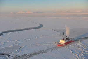 Vessel breaking through Arctic sea ice