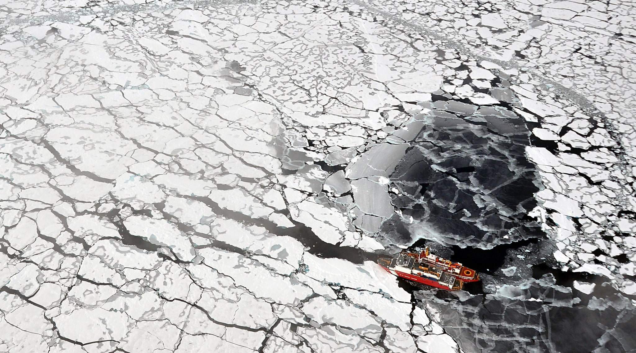 Two vessels navigating through Arctic sea ice