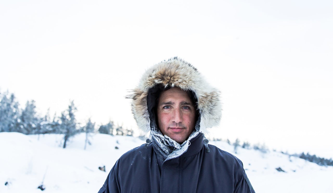 Man with hood standing in snow