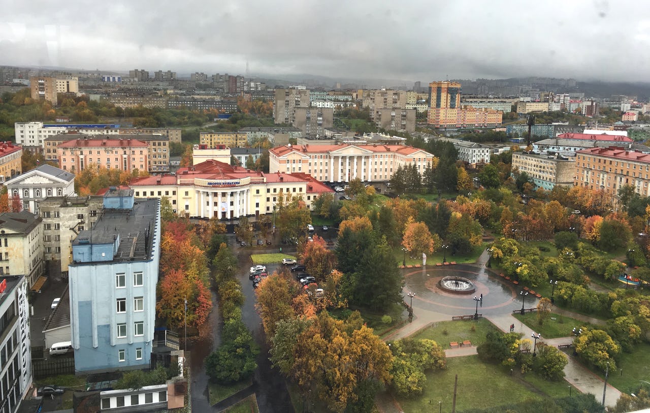 Buildings and park in Murmansk with grey sky.