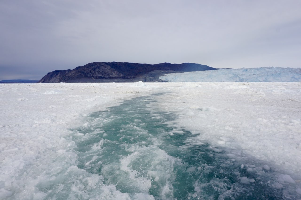 Melting ice sheet with glacier in background