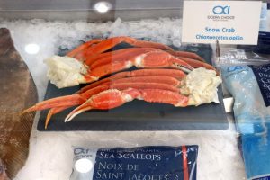 Legs of snow crabs on ice cubs in a class cabinet