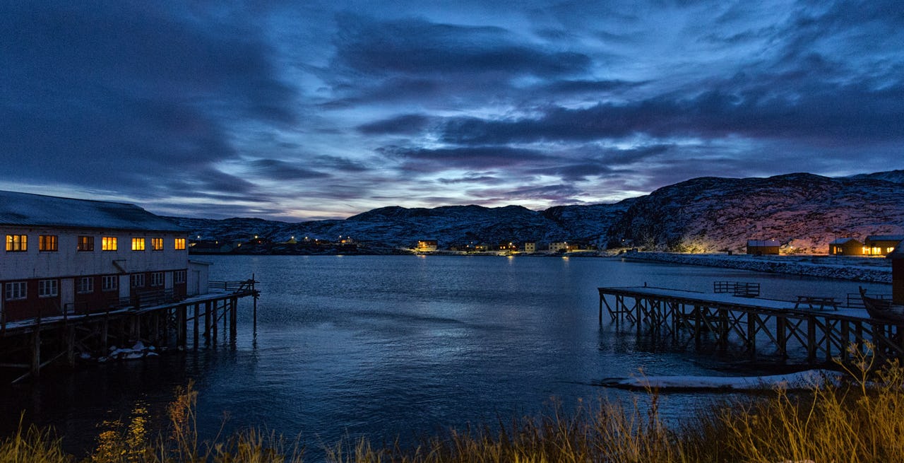 Wooden houses by the ocean at sundown