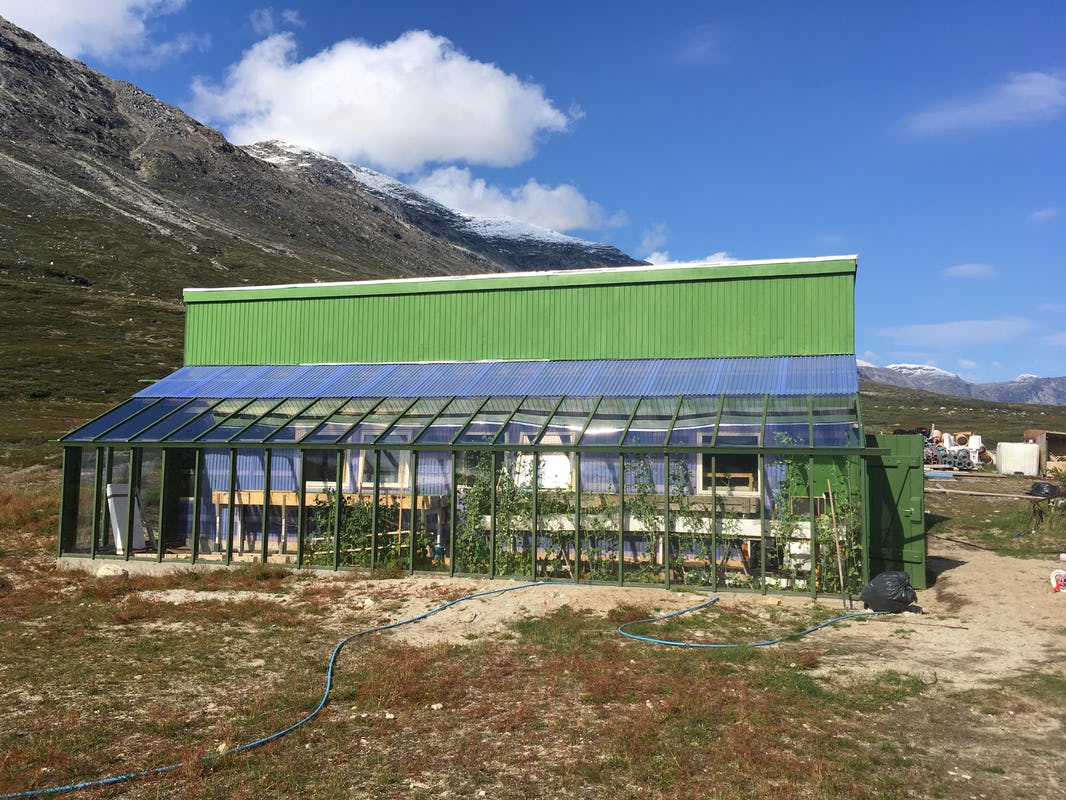 Greenhouse in front of mountains during summer