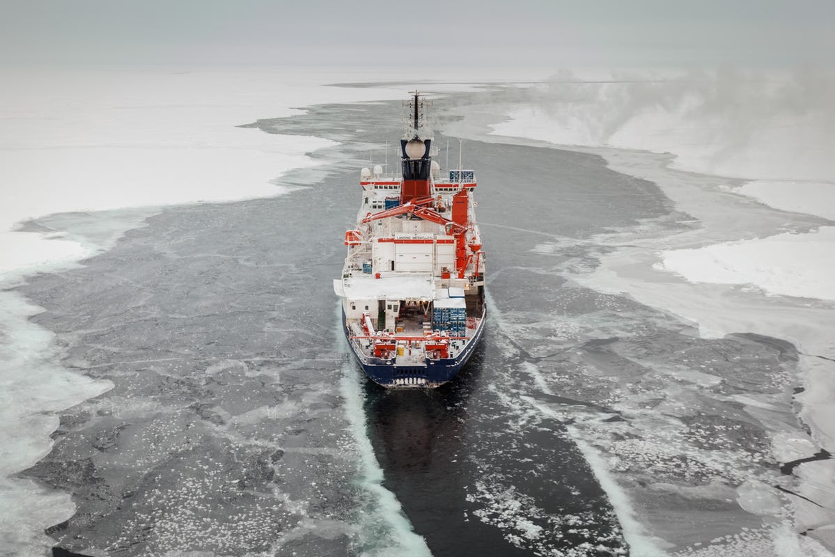 Ship from behind charting through icy waters