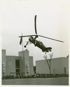 Black and white photo of a plane landing on the ground