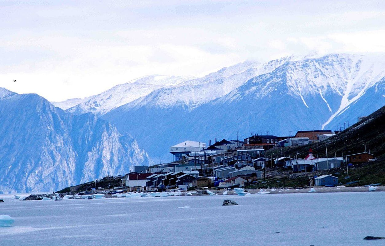 House at shore with mountains in the background