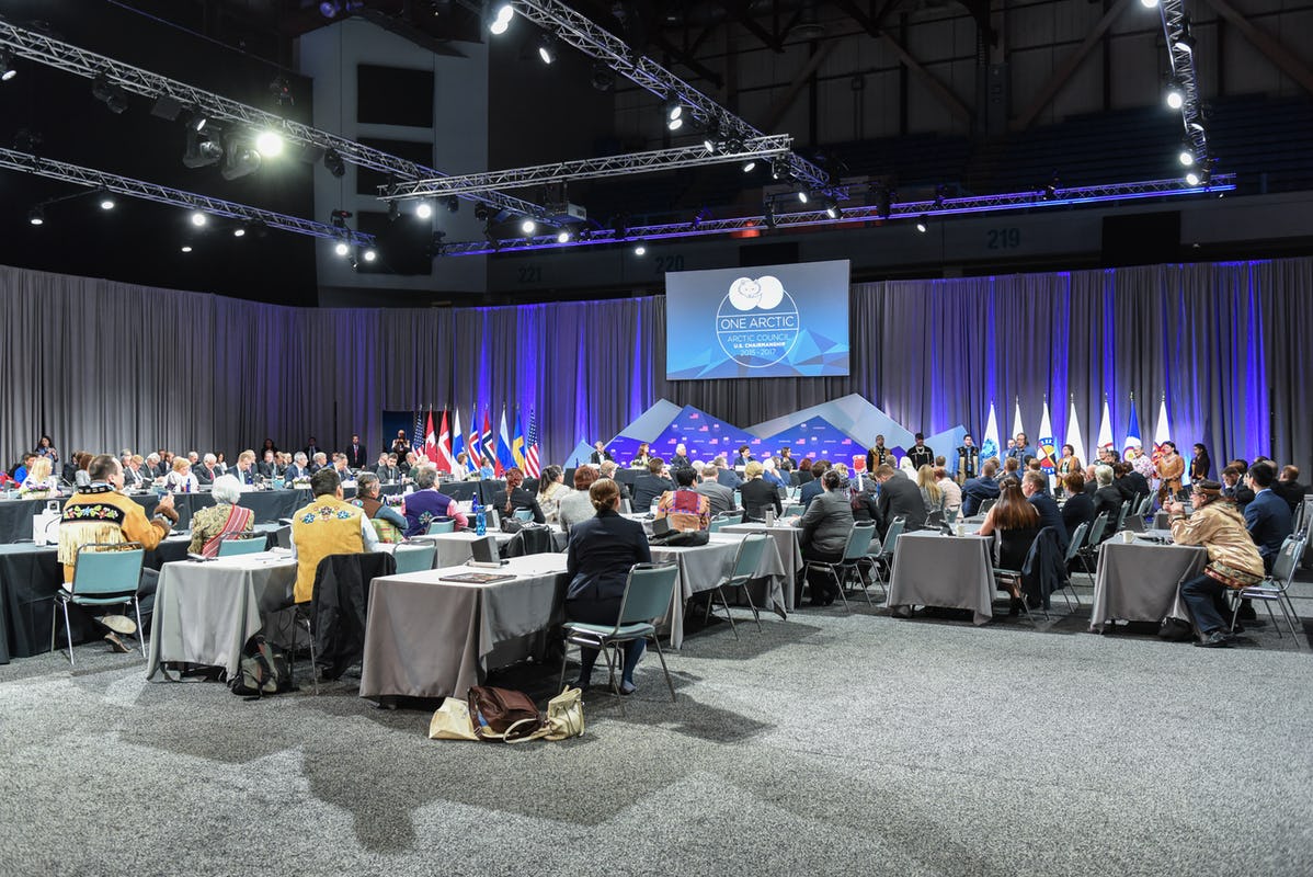 People sitting at tables in conference room