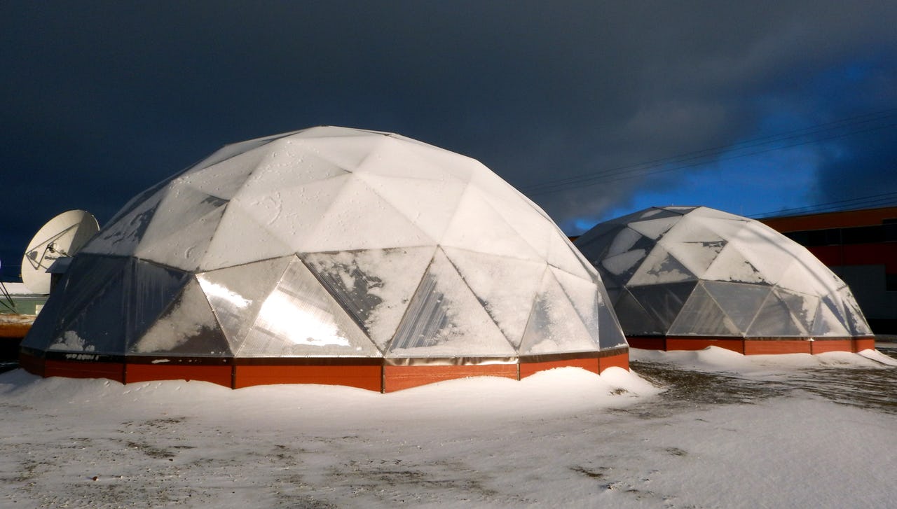 Solar powered greenhouses covered by snow