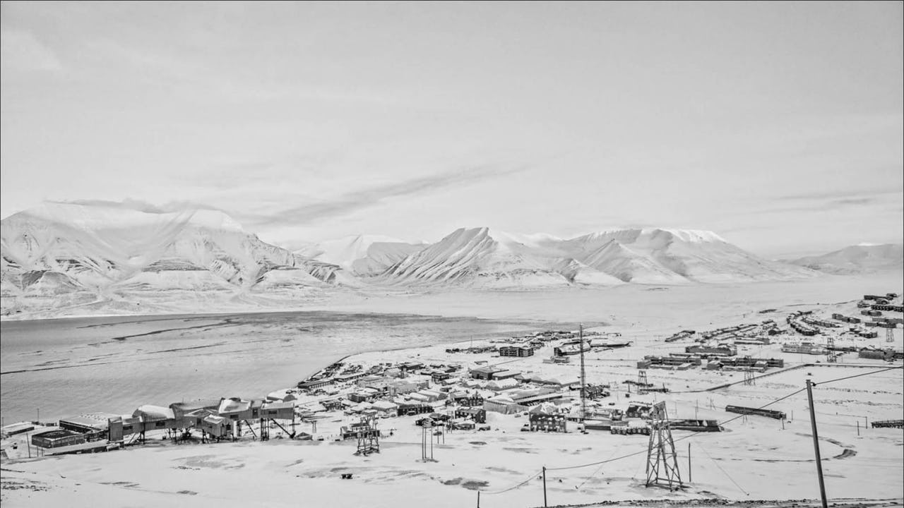 Black and white photo of the town of Longyearbyen in Svalbard covered in snow