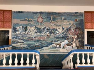 A colourful mosaic depicting polar bears and snowy mountains flanked by a white bannister