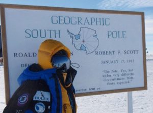 Woman in snowsuit pictured at Geographic South Pole