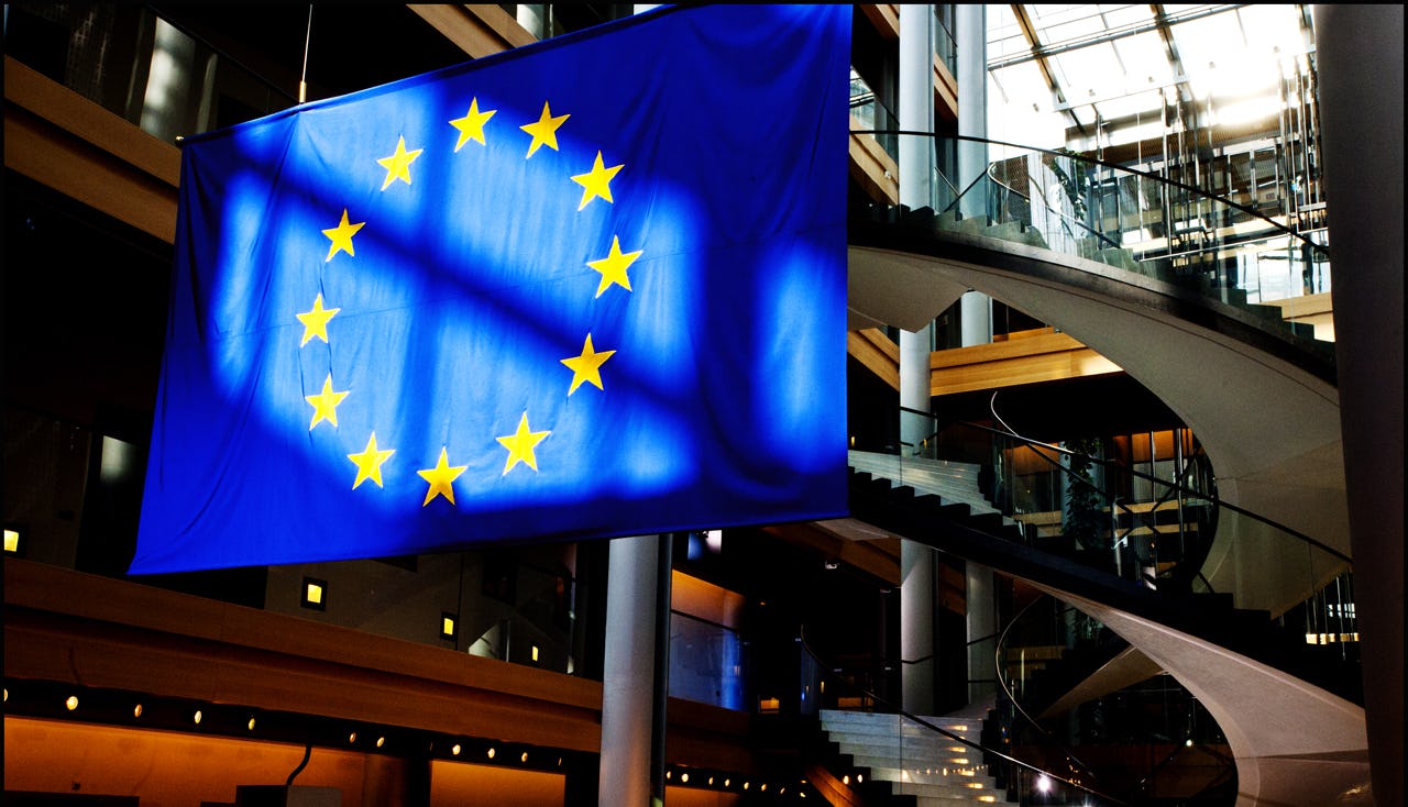 Flag of the European Union hanging from roof in building