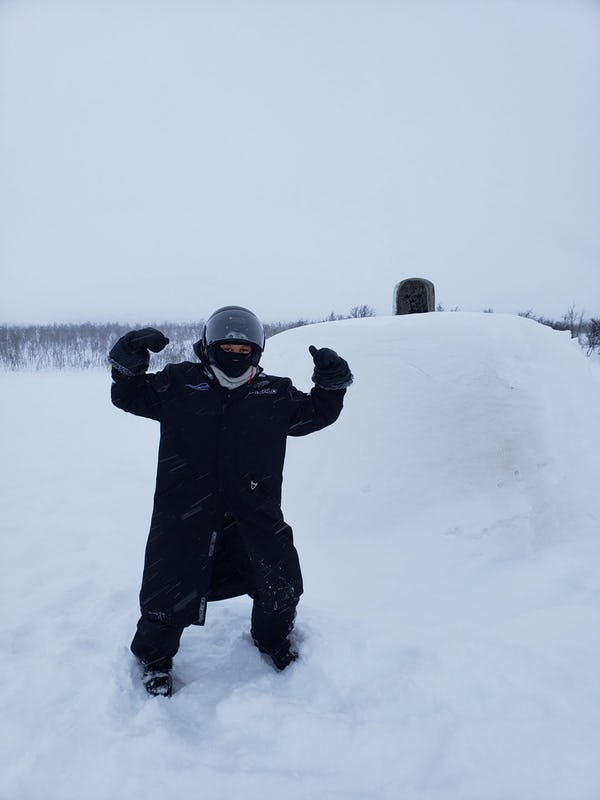 Woman in front of monument covered in snow