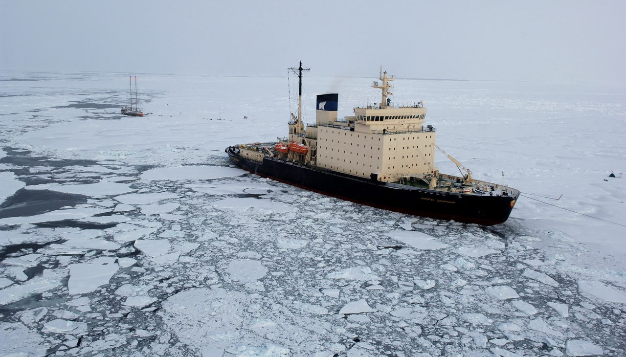A large boat surrounded by ice