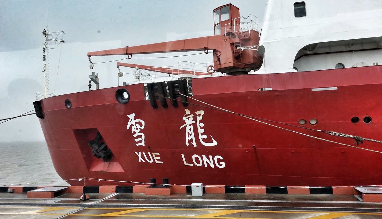 Red-white vessels with name in Chinese characters at dock