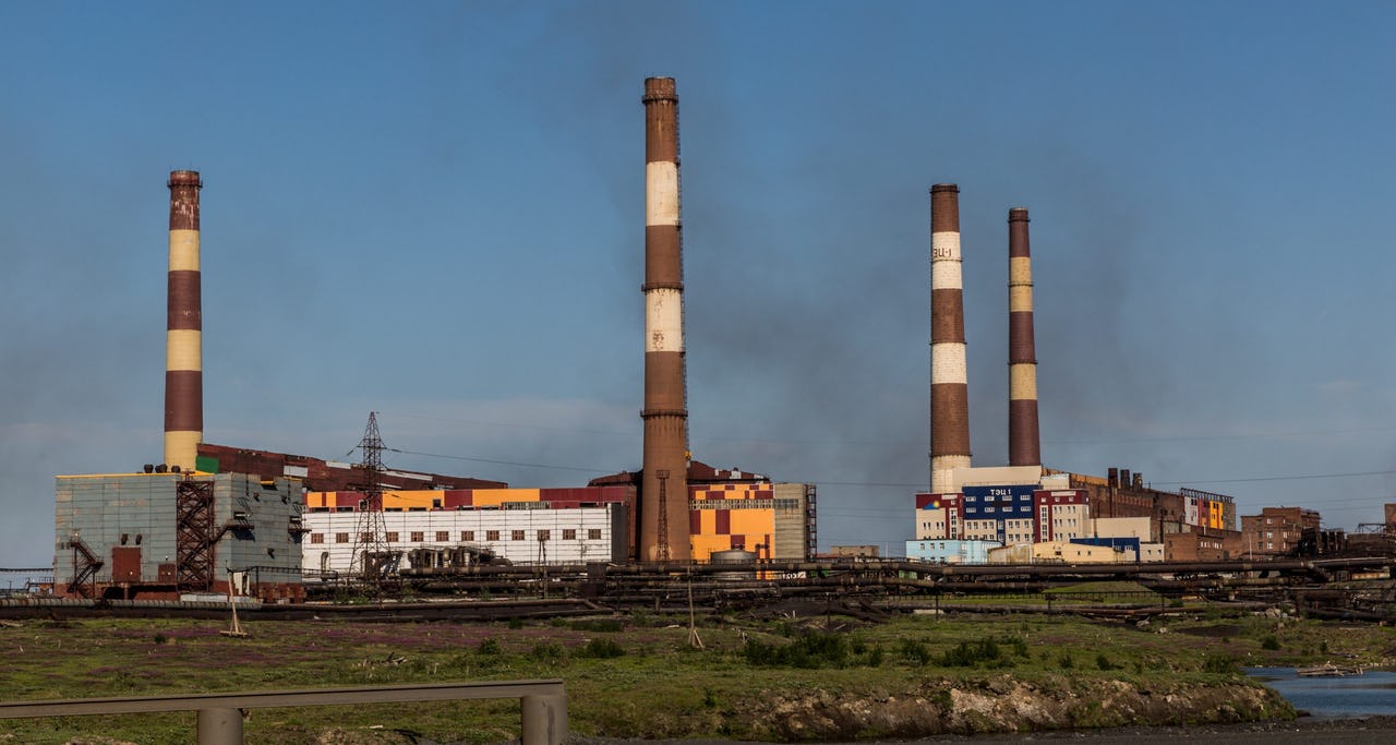 A factory with a blue sky in the background