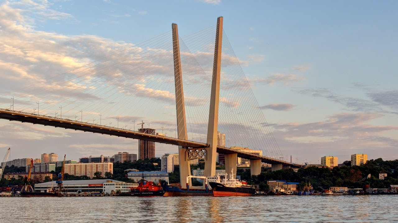 A bridge over water with ships under it