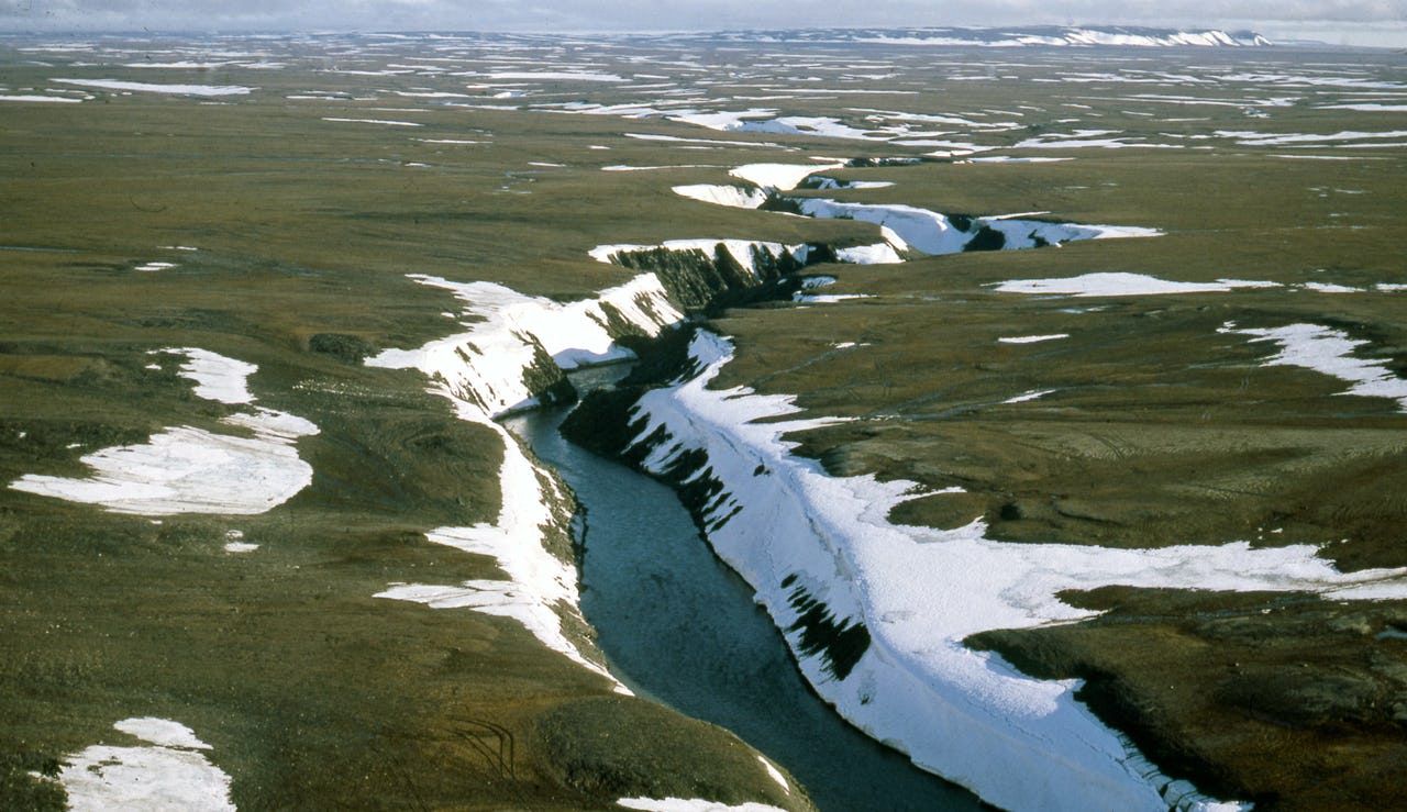A large crevasse in the earth with running water in it
