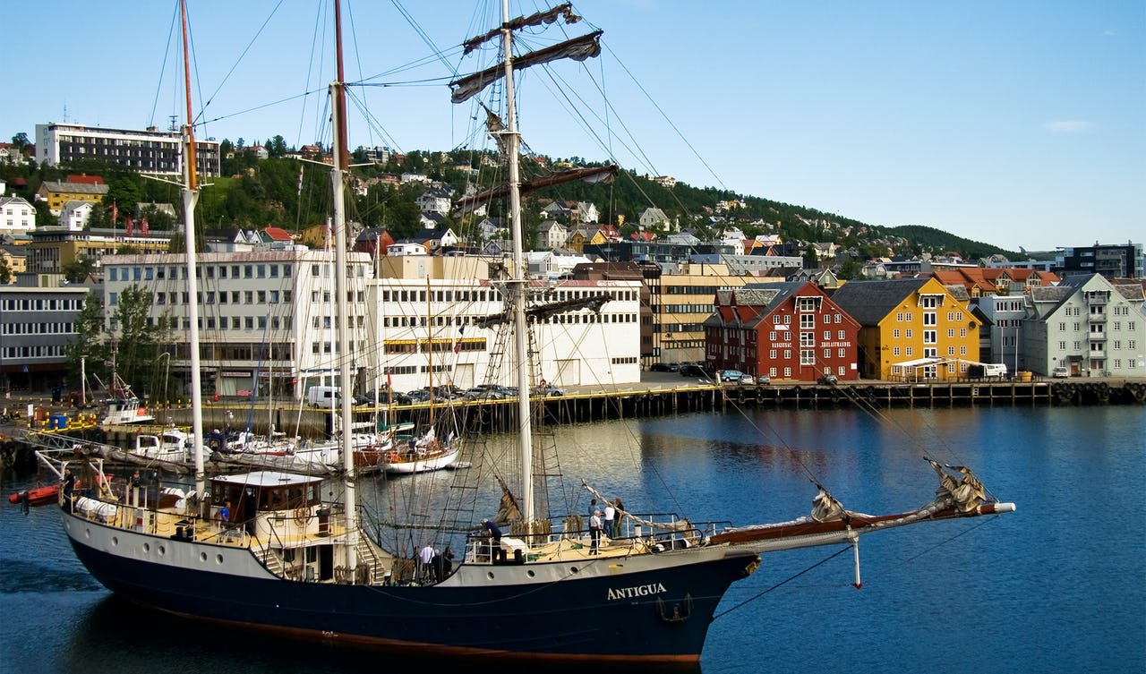 Sail boat in water with buildings in background