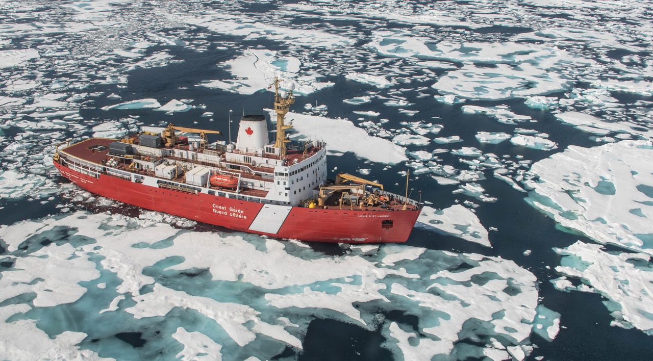 Vessel breaking through Arctic sea ice