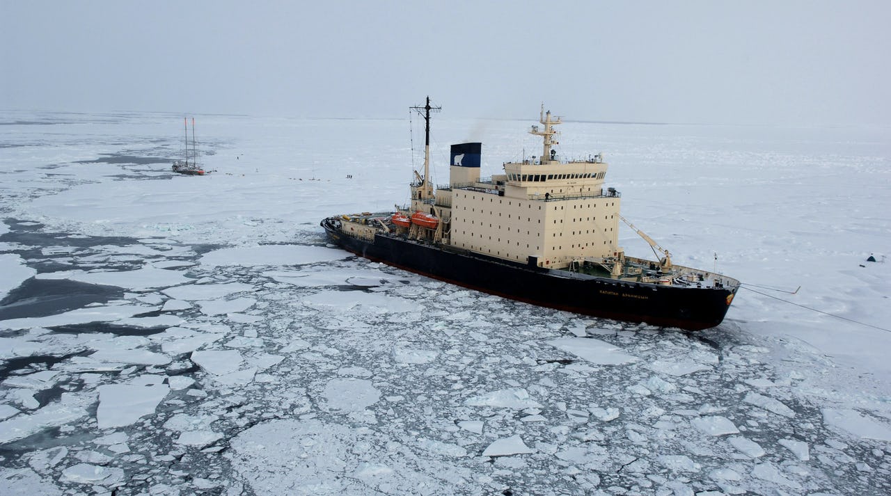 Cargo ship in the Arctic surrounded by ice