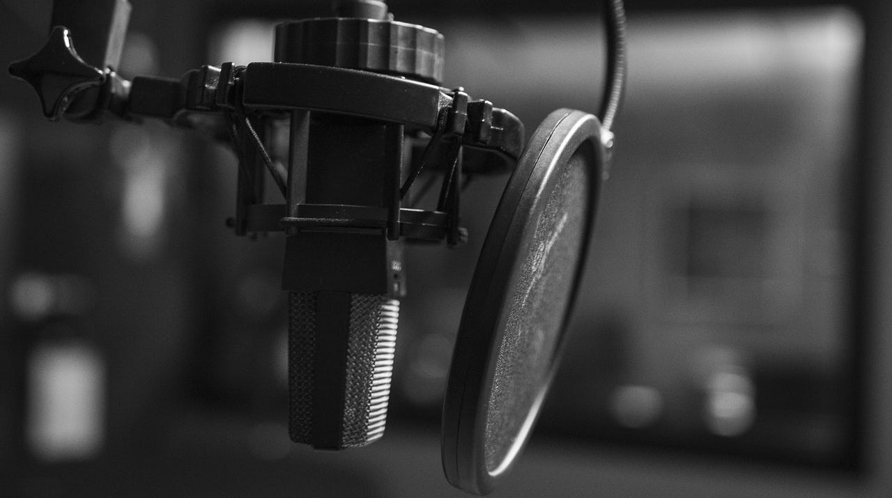 A black and white photo of a podcast microphone