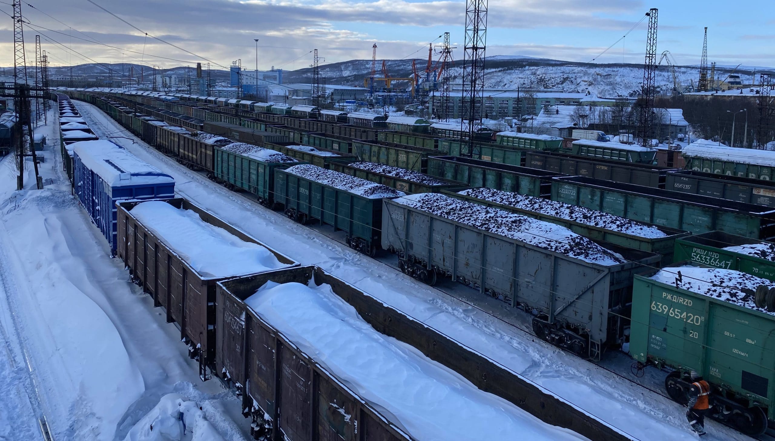 Trains covered in snow in a railway station