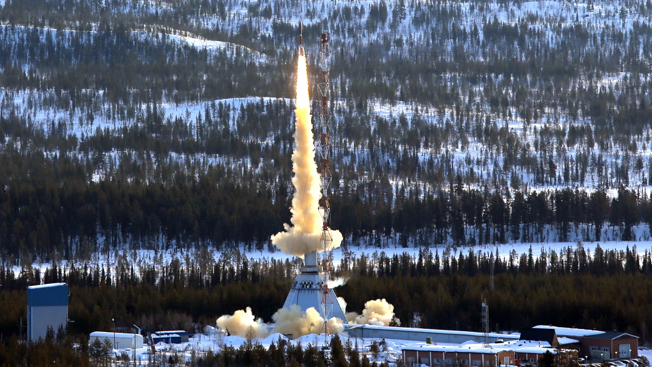 Launch of rocket from ESRANGE space center in Kiruna, Sweden, surrounded by trees