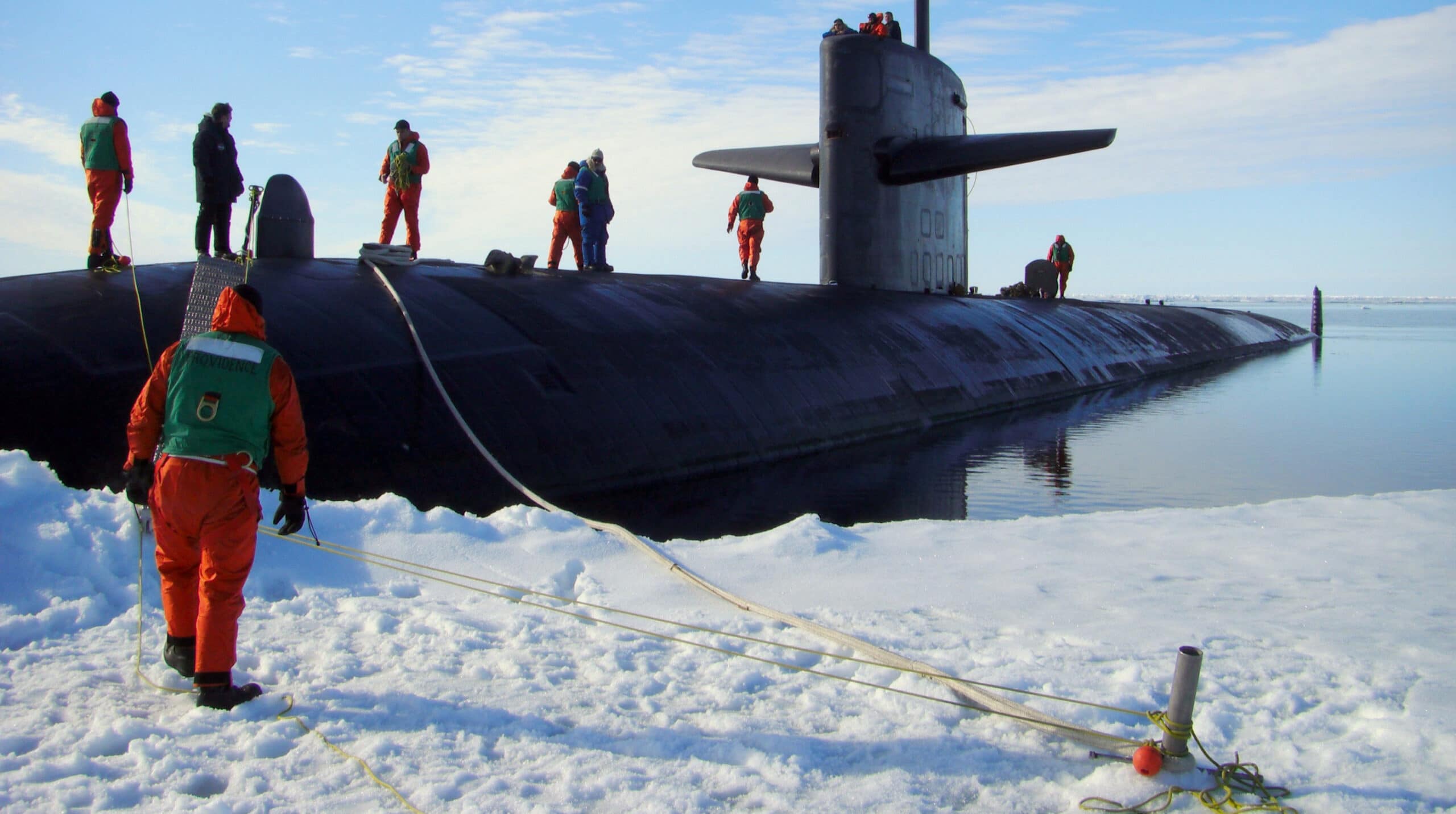 USS Providence docked at ice with sailors standing on the submarine