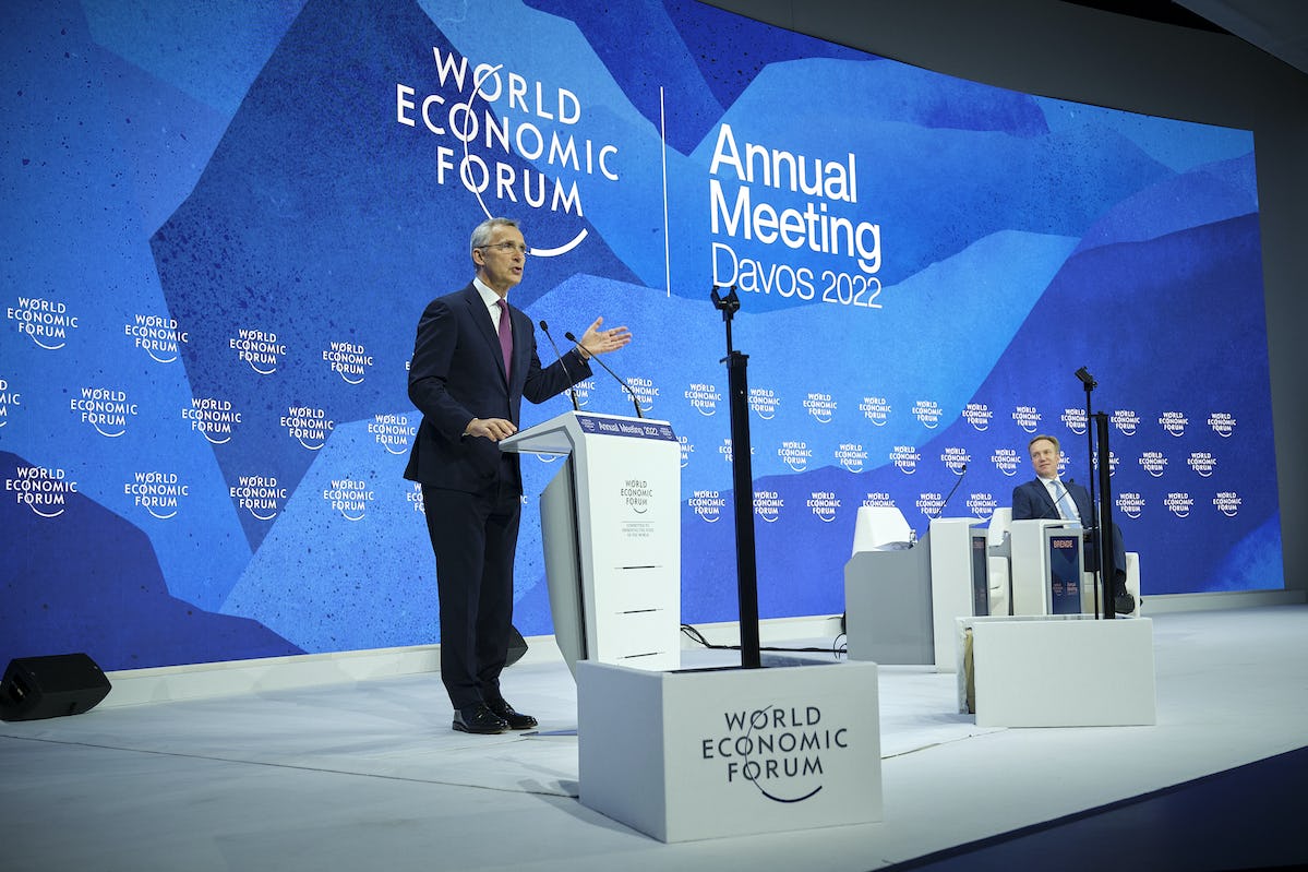 Jens Stoltenberg standing behind a speaker's desk giving a speech at the World Economy Forum 2022
