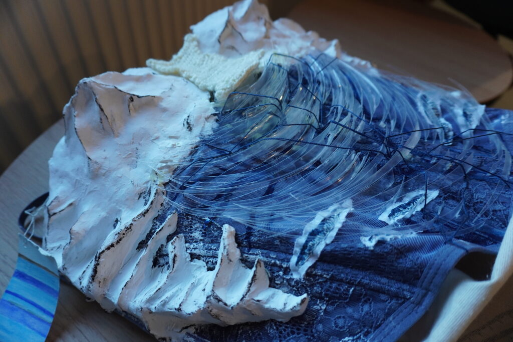 A photograph of the corset staged on a table to show each component