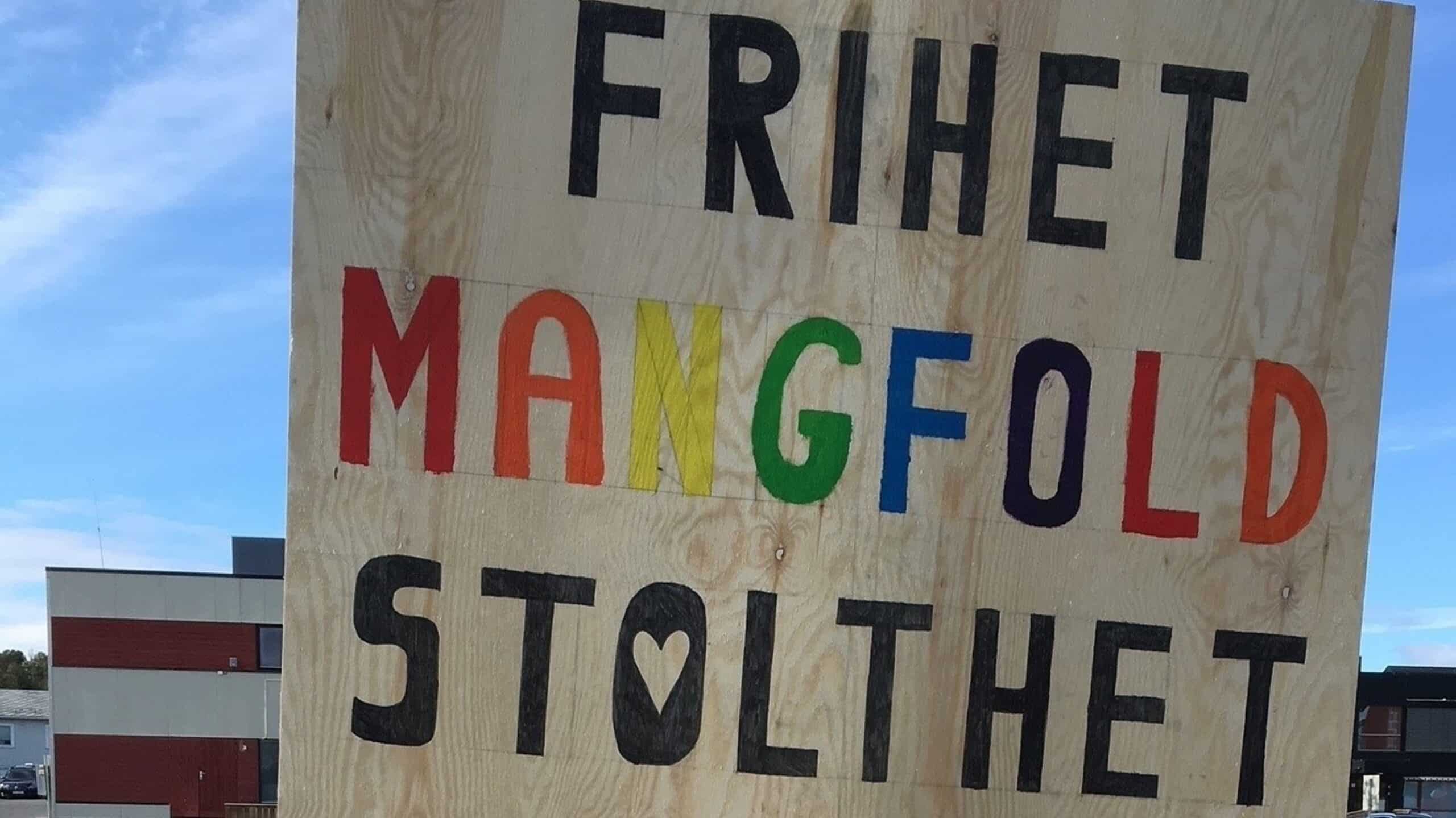 A wooden sign of the LGBTQ+ Pride in Alta, Norway