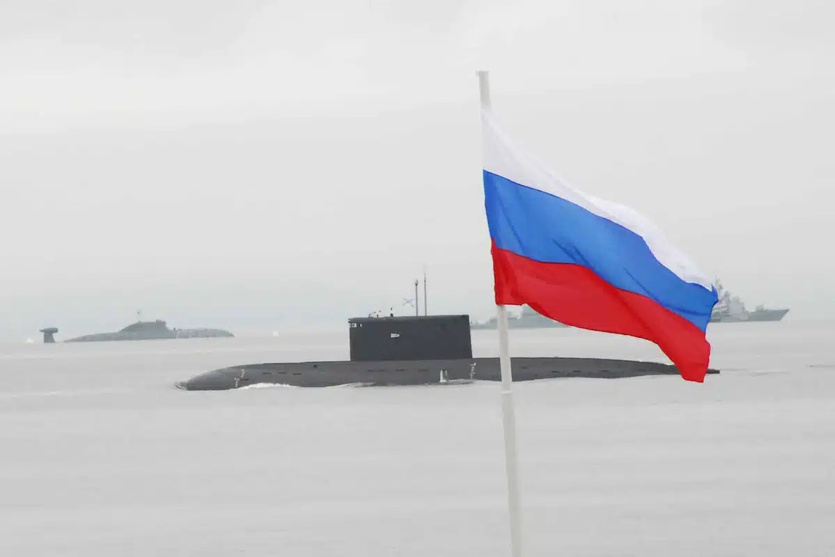 Two submarines behind a Russian flag
