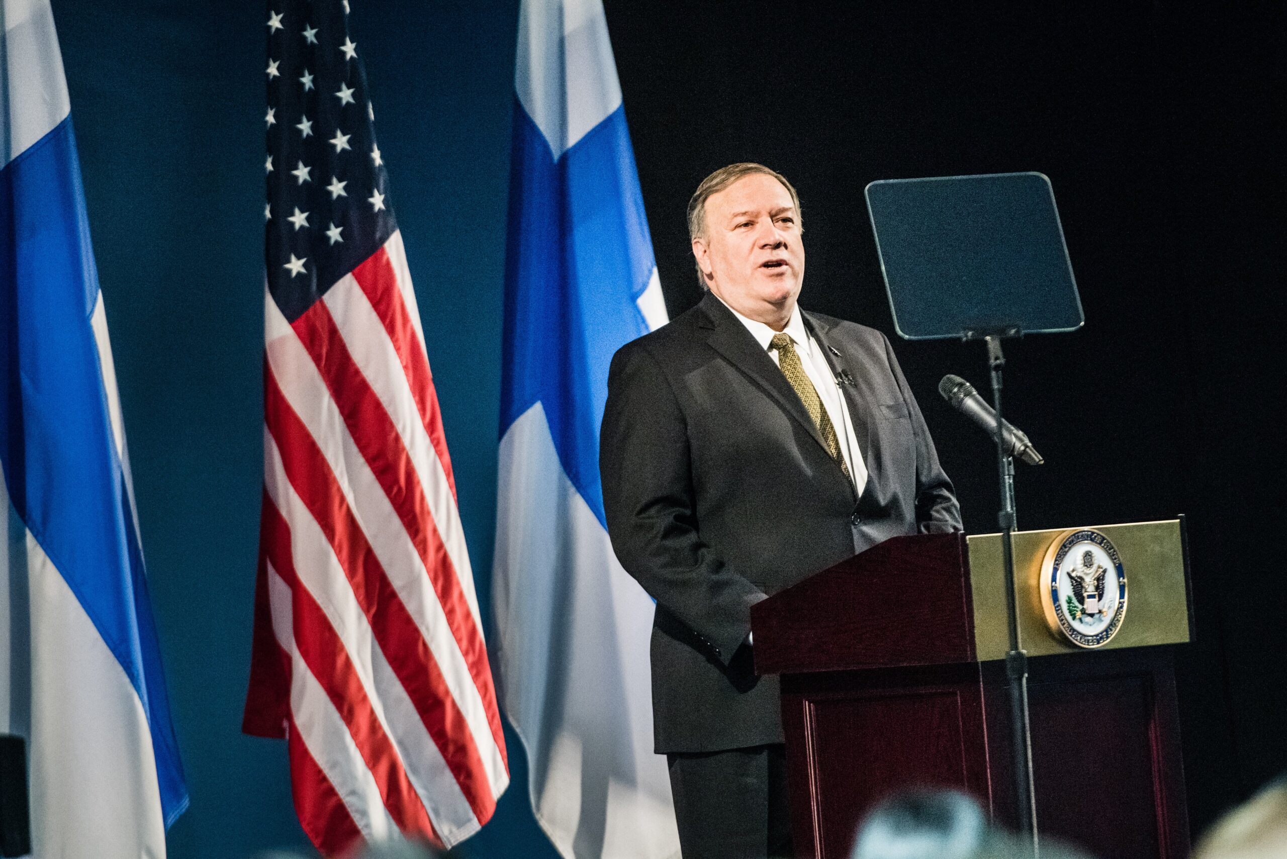 Then-U.S. Secretary of State Mike Pompeo at a rostrum, with the Finnish and United States' flags in the background