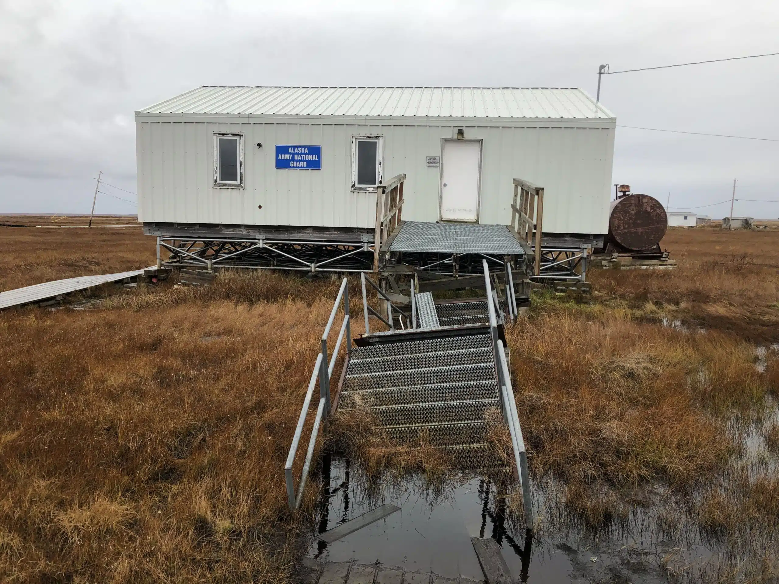 A building sinking into the thawing permafrost in the Native Village of Nunapicuaq (Nunapitchuk), Alaska