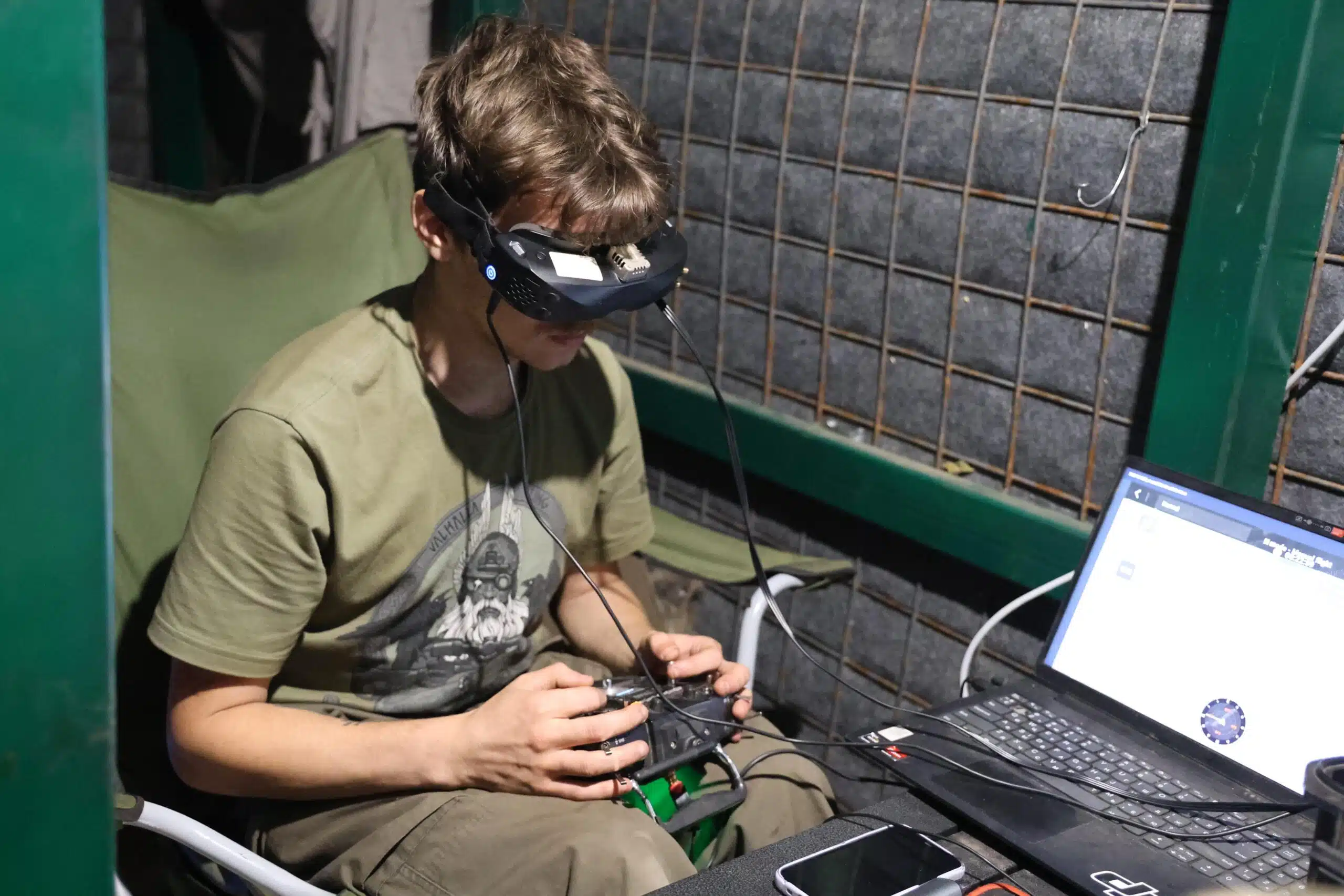Ukrainian drone pilot with goggles, piloting an FPV drone during a frontline mission in Donetsk Oblast
