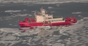 A red Chinese research vessel in ice waters, observed with a green imagery system by the U.S. Coast Guard in the Alaskan Arctic